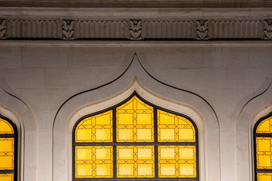 Night view of lit windows on the octagon of the Shrine of the Báb