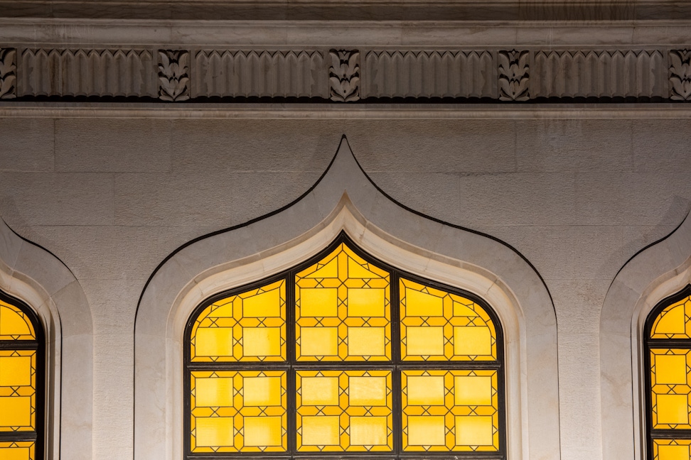Night view of lit windows on the octagon of the Shrine of the Báb