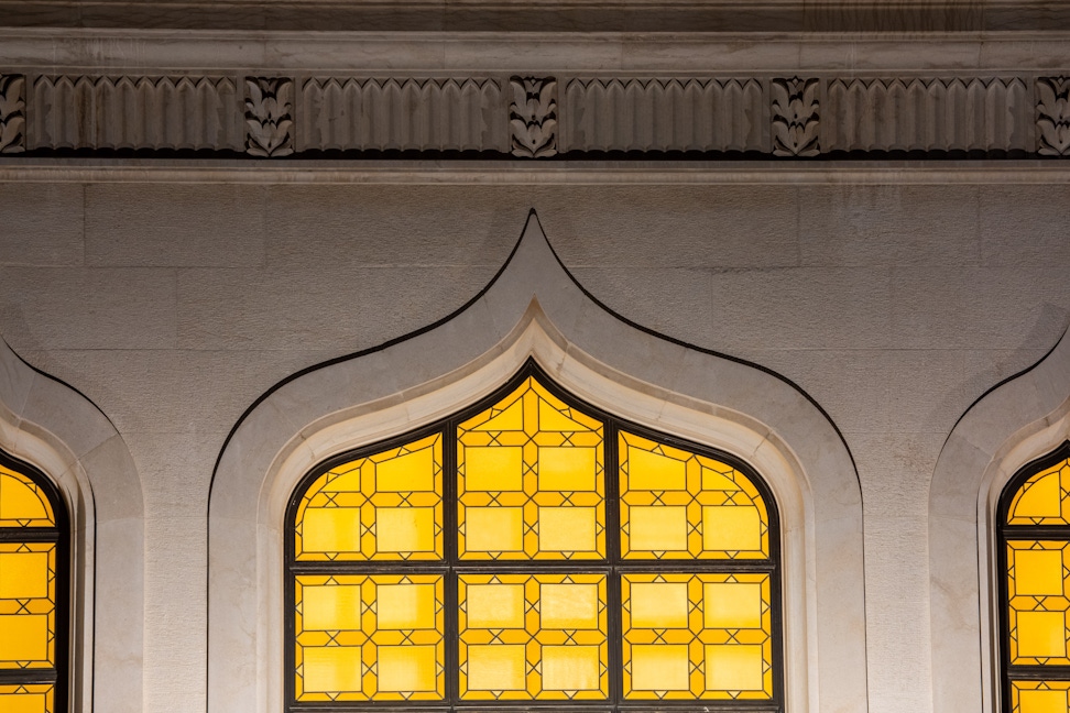 Night view of lit windows on the octagon of the Shrine of the Báb