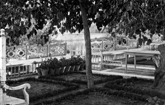 The flower pots on the ground mark the location of the bench where Bahá’u’lláh often sat when He visited the garden, c. 1920