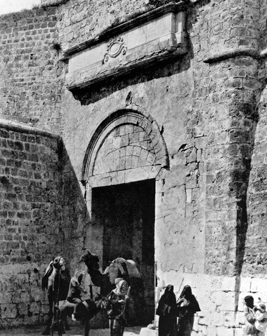 Bahá’u’lláh departed the city of ‘Akká in 1877 through the land gate, seen here from outside the city walls, 1921