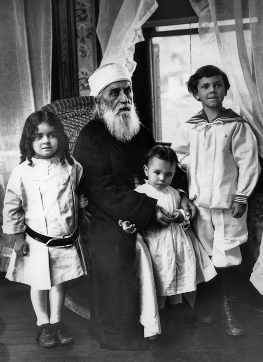 ‘Abdu’l-Bahá with three children, 1912