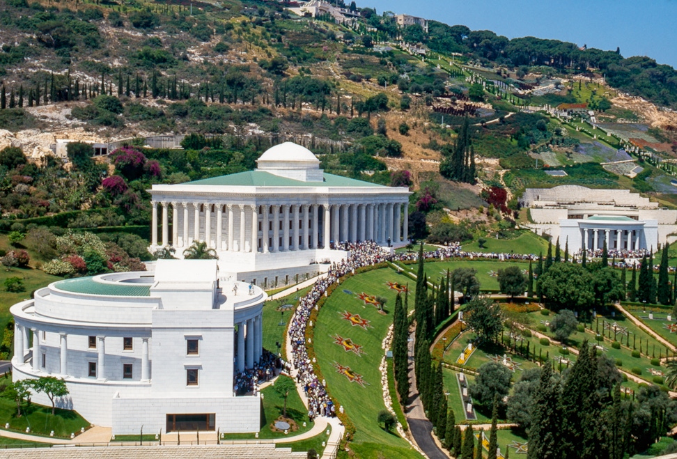 Participants gathered on the Arc in front of the Seat of the Universal House of Justice (centre), the International Teaching Centre (left) and the Centre for the Study of the Sacred Texts (far right) at the opening of the Terraces of the Shrine of the Báb, May 2001