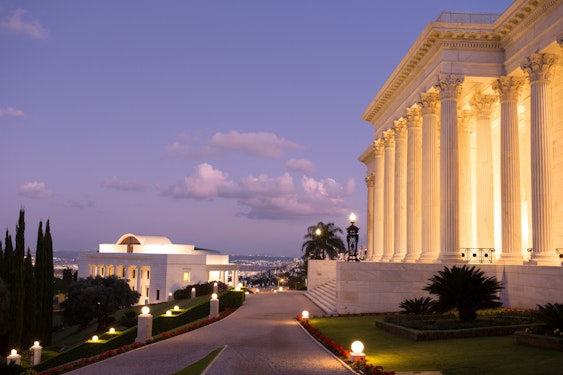 The International Teaching Centre Building (left) and the Seat of the Universal House of Justice (right) at night 
