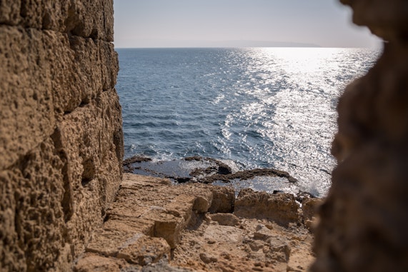 The Mediterranean Sea viewed from between the battlements of the sea wall 
