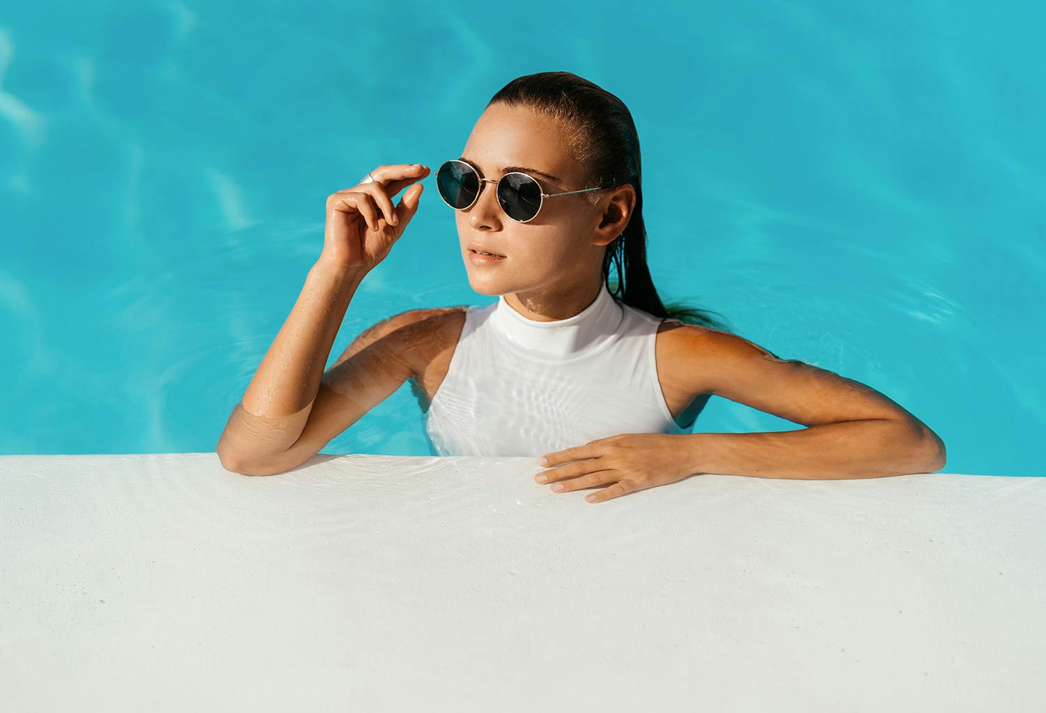 Woman in a Pool with Sun Glasses On