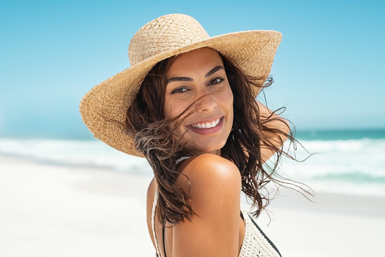 Woman wearing a sunhat smiling
