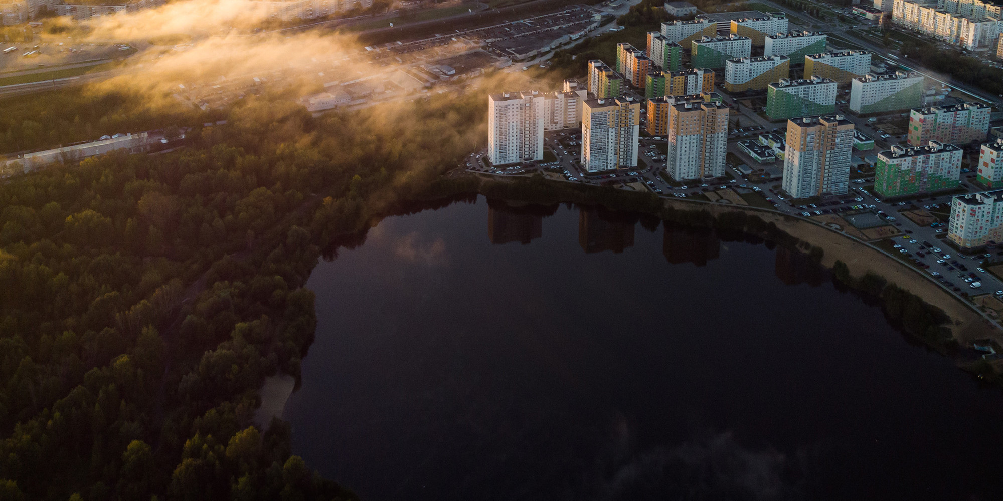 City from above with high-rise apartment buildings next to a lake