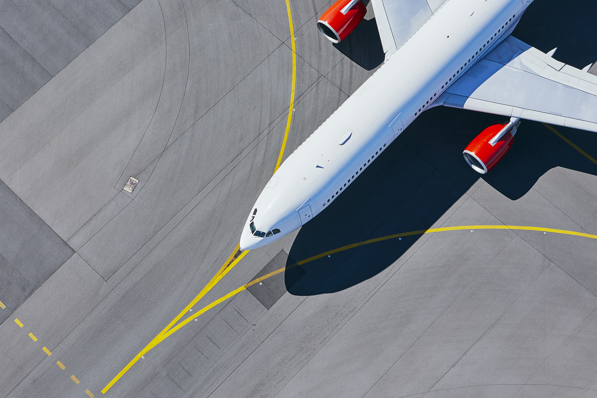 Aerial view of a plane taxiing at an airport