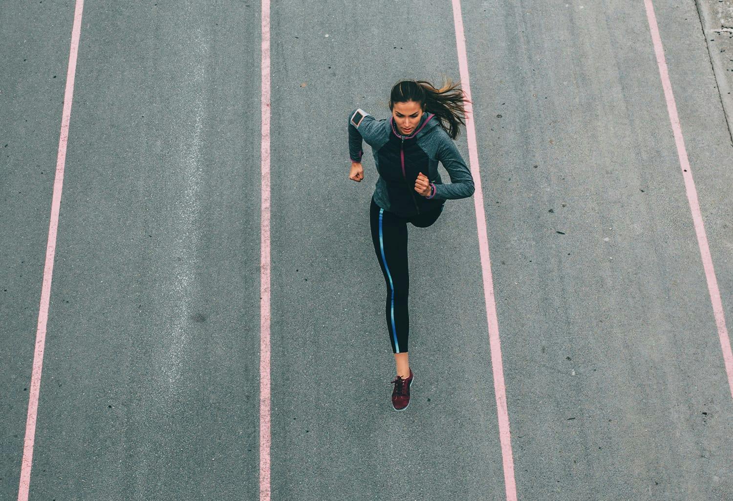 Woman running on a track