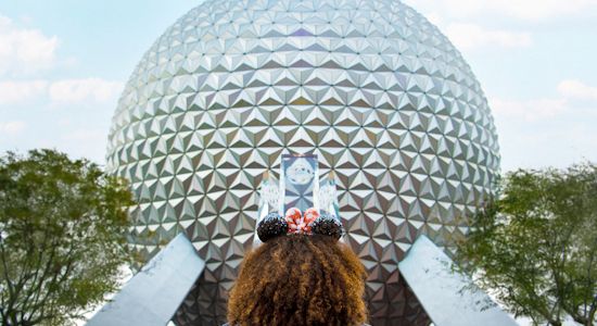 Girl Standing in Front of Spaceship Earth Wearing Mickey Ears