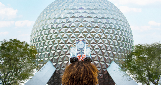 Girl Standing in Front of Spaceship Earth Wearing Mickey Ears