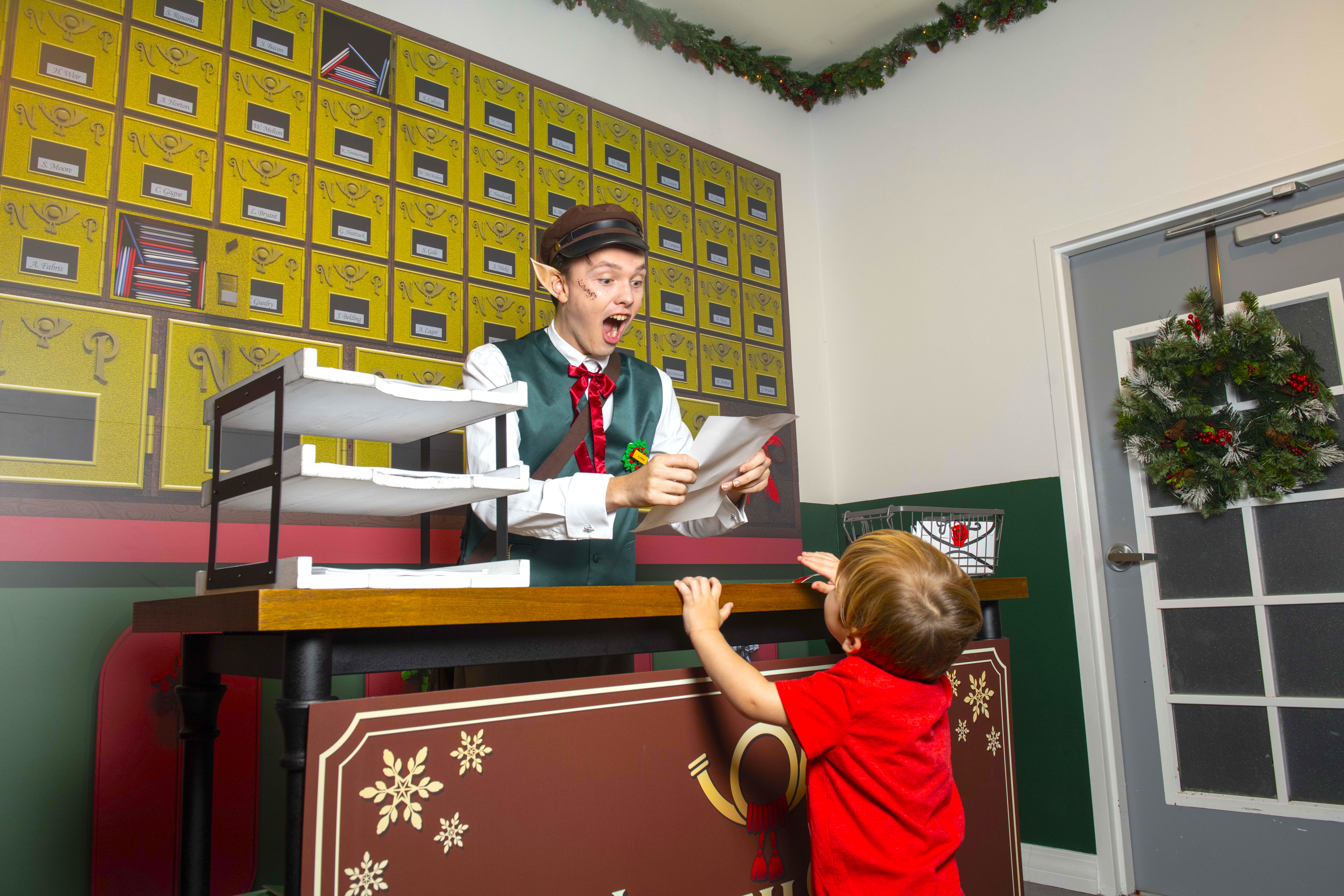 Elf Postal Worker in the North Pole Postal Office Reading a Letter from a Child