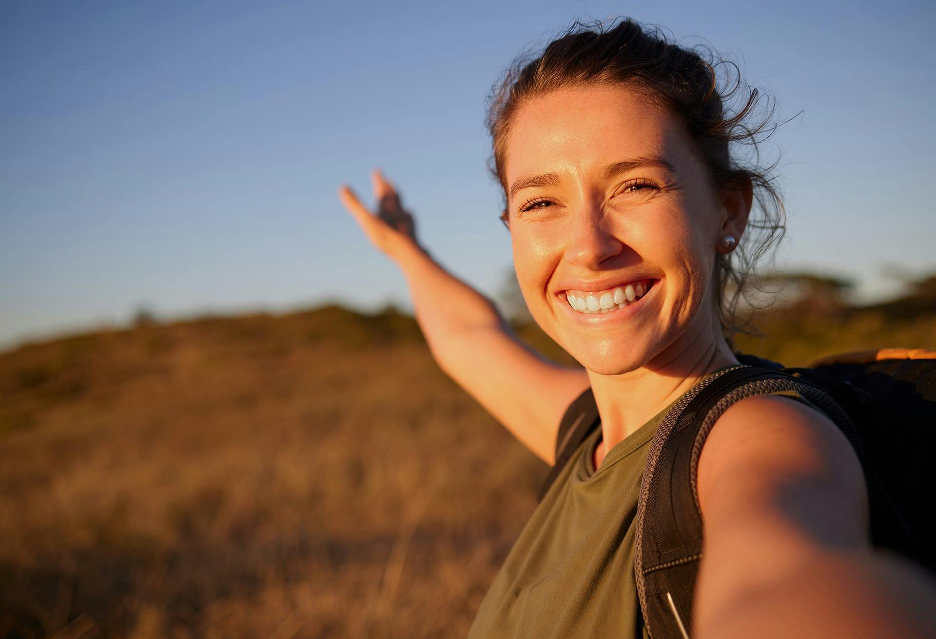 Woman holding her arm up on a hike