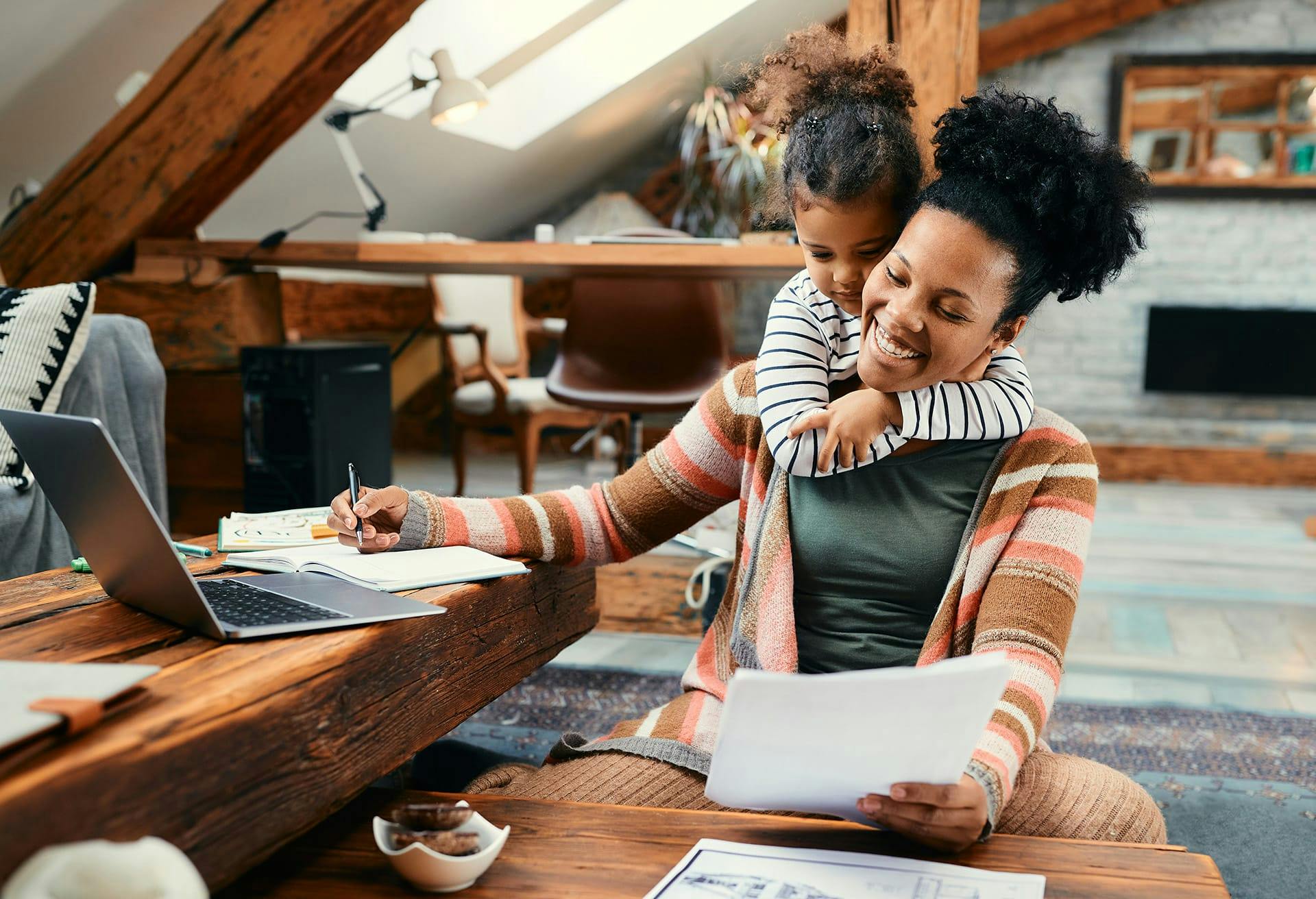 Woman reading a paper while child hugs her from behind