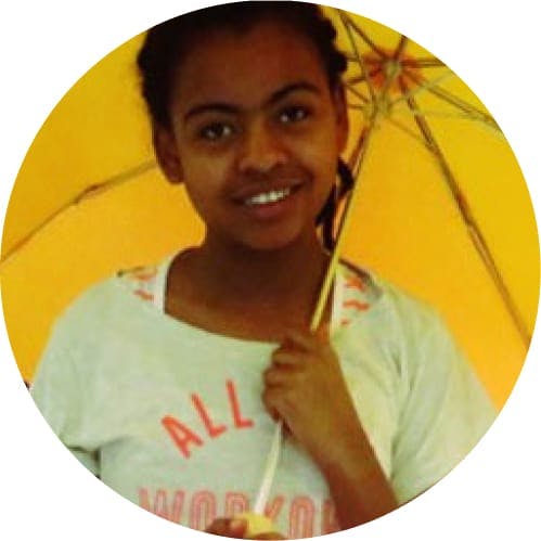 A little girl holding an umbrella
