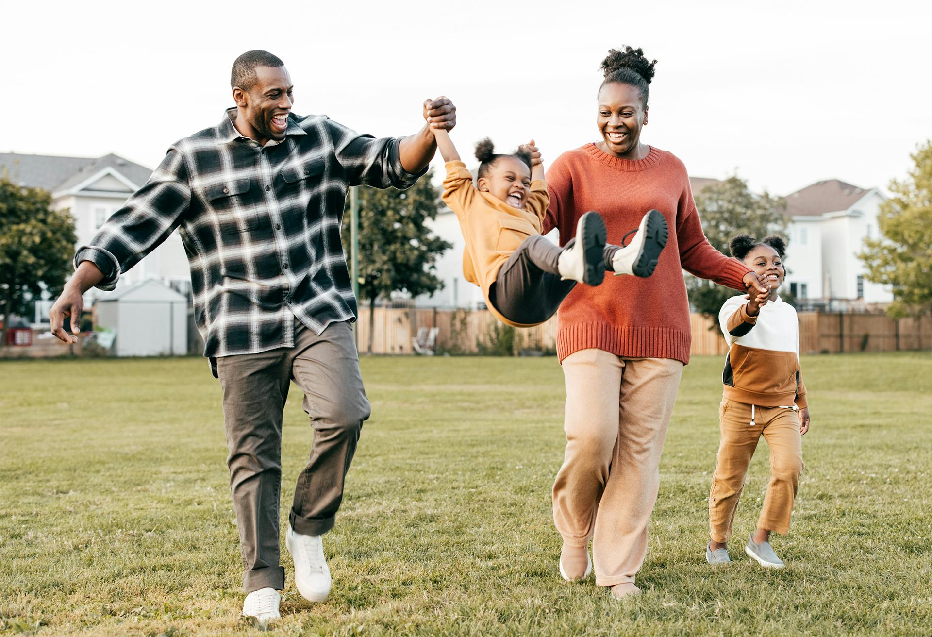 Man, woman and 2 kids playing in a park