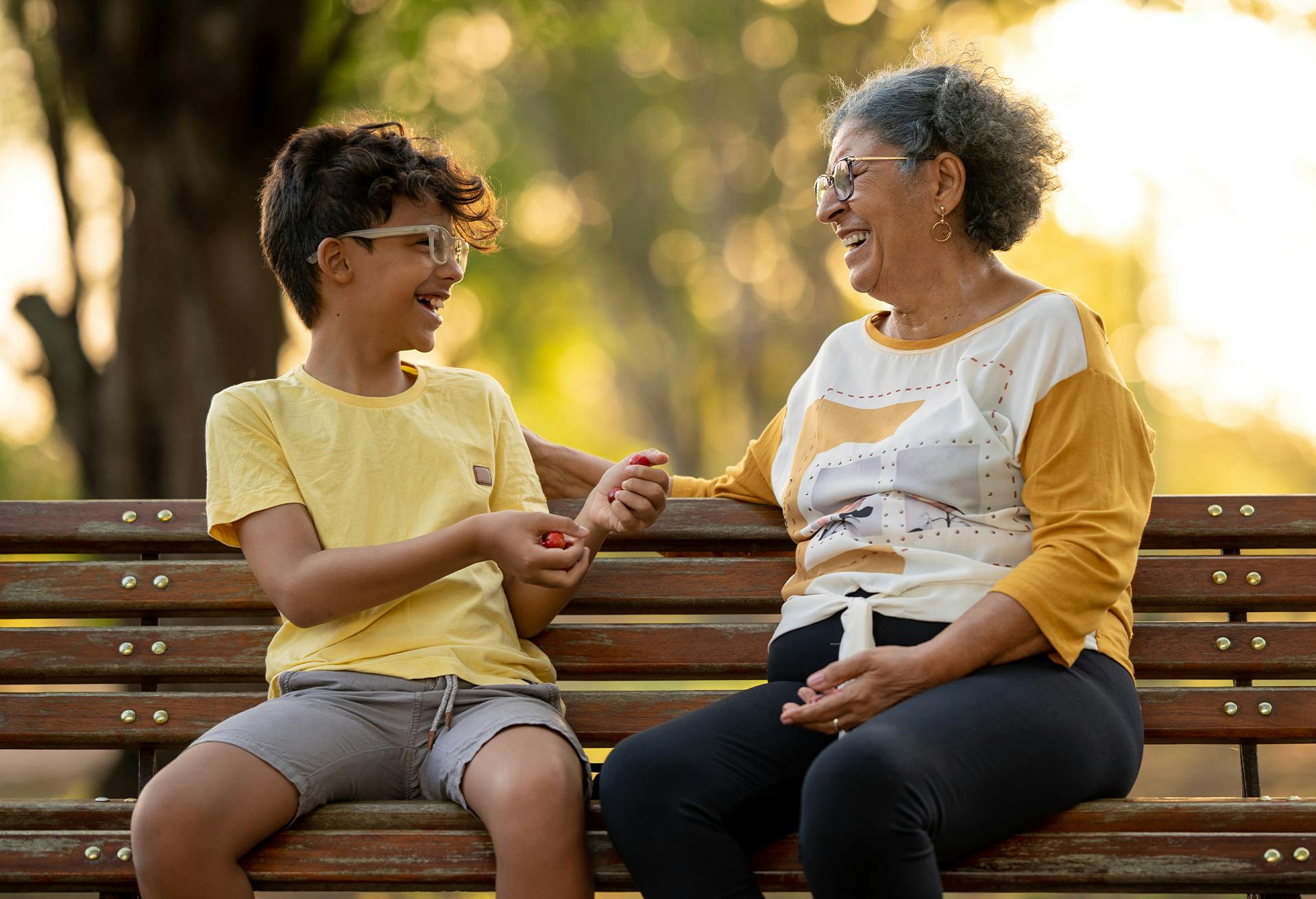 Woman and child sitting on a park bench