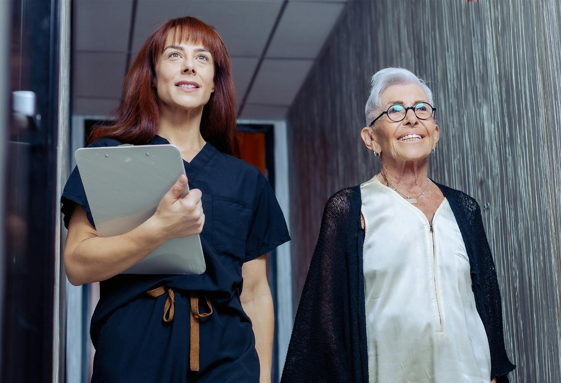 Woman walking down the hall with nurse, close-up