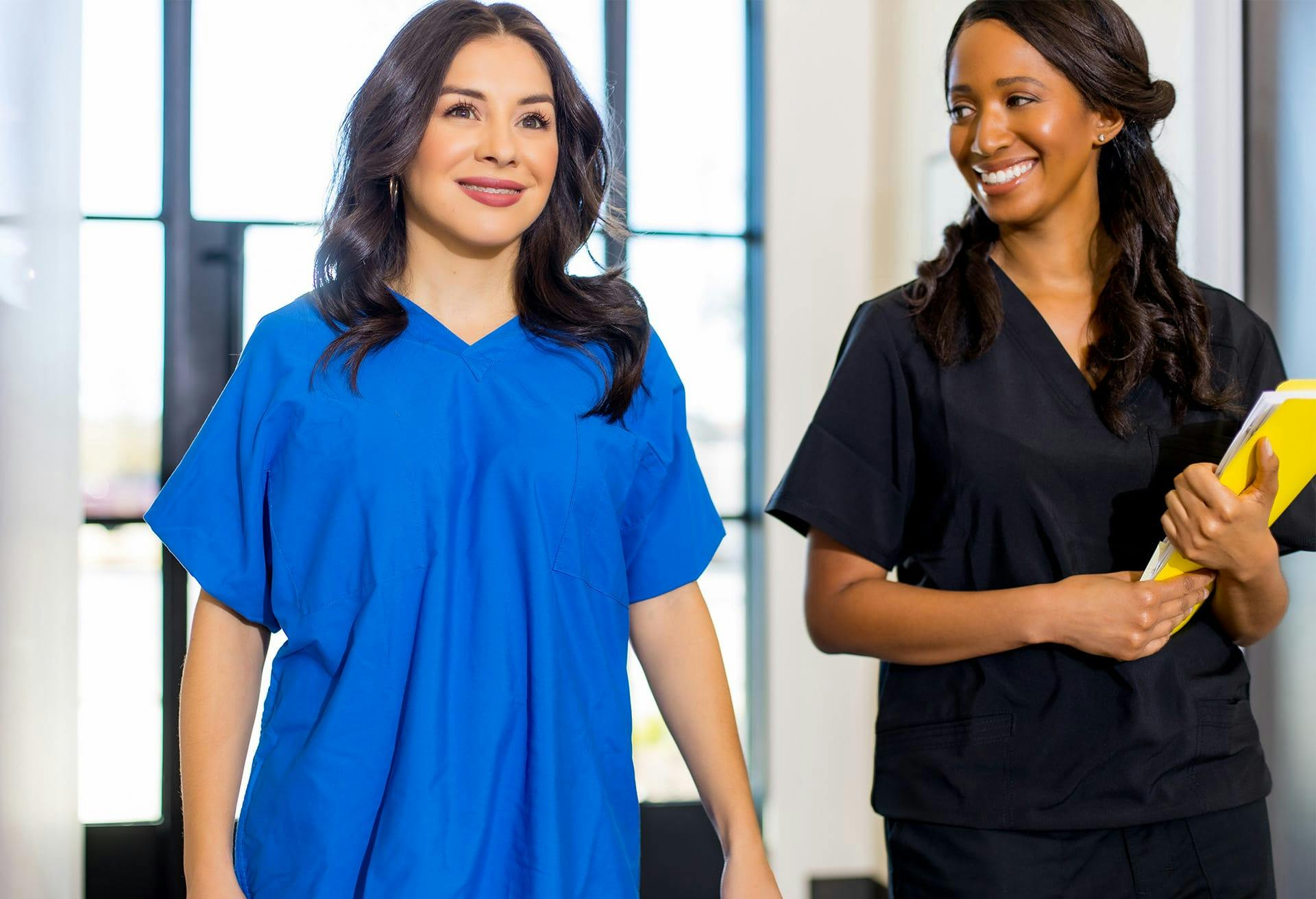 Two nurses walking in hallway