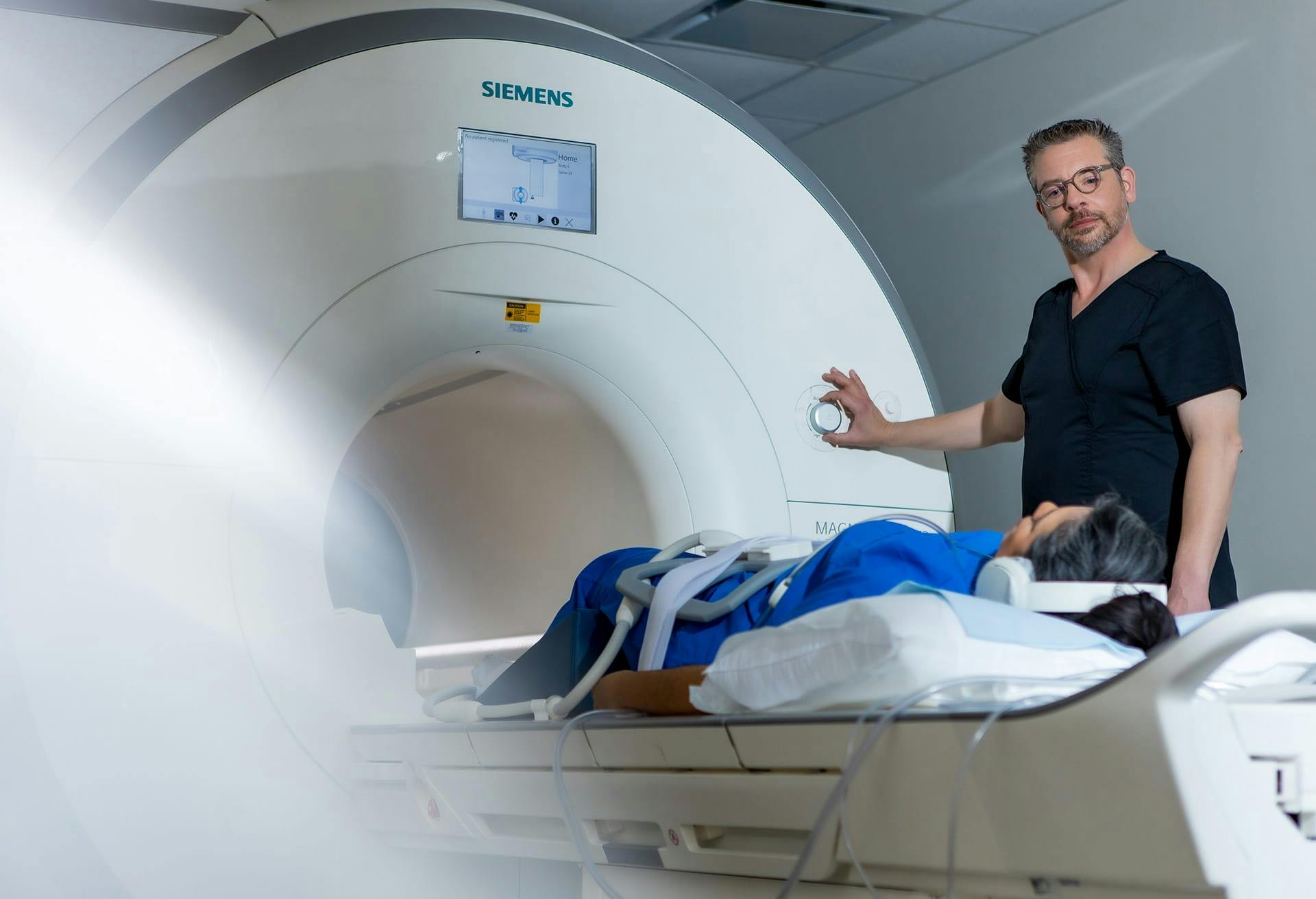 Man administrating and Magnetic Resonance Imaging (MRI) test