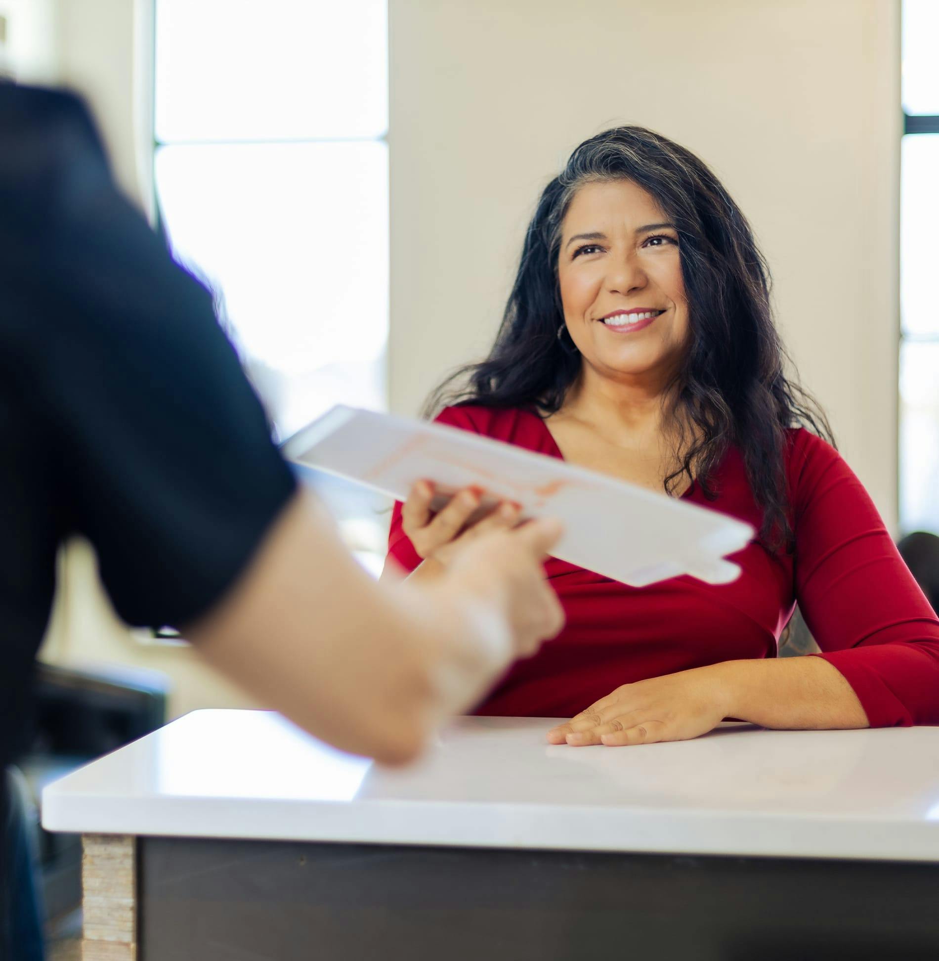 Longhorn imaging patient holding paper across from doctor