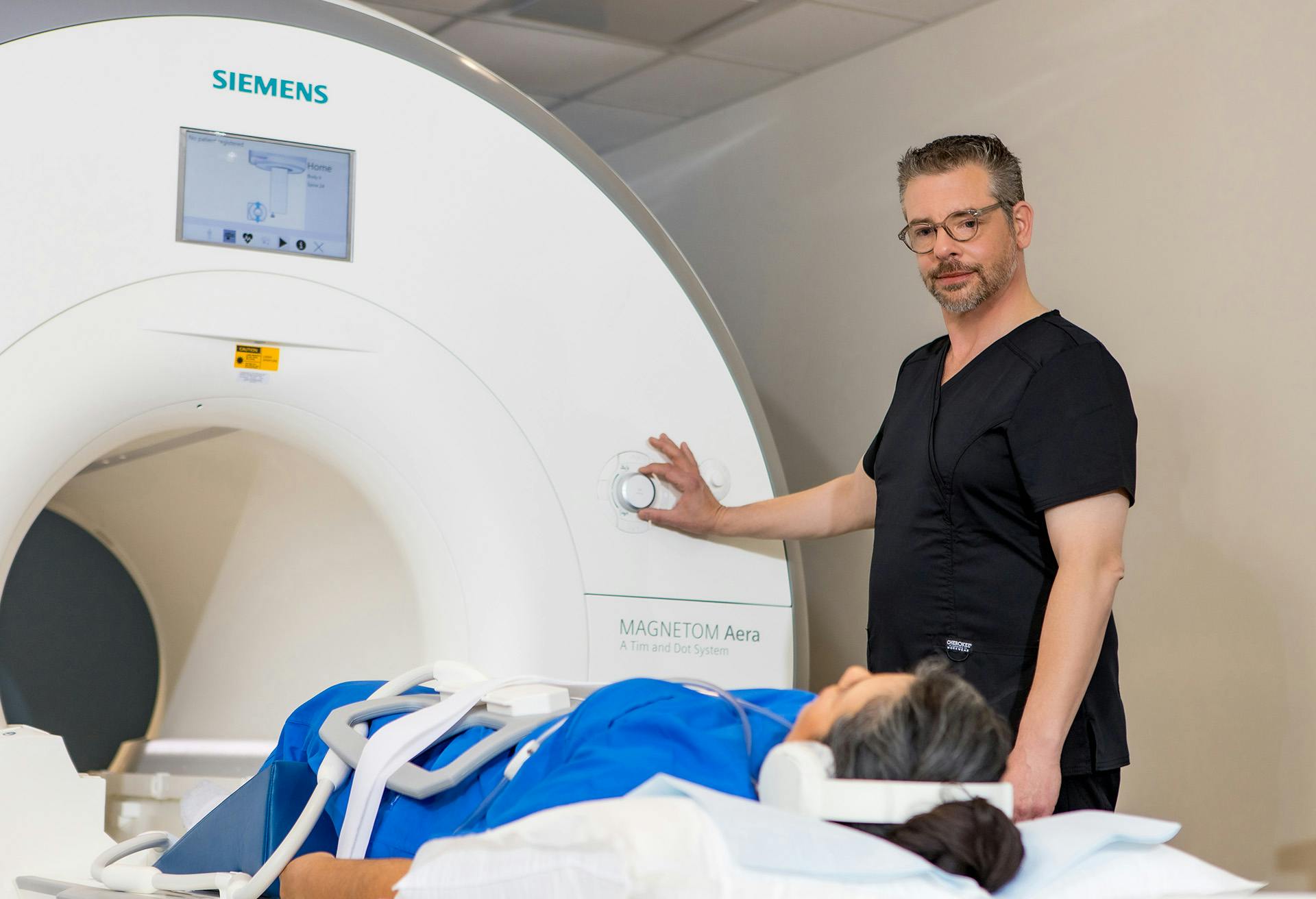 man administrating and Magnetic Resonance Imaging (MRI) test