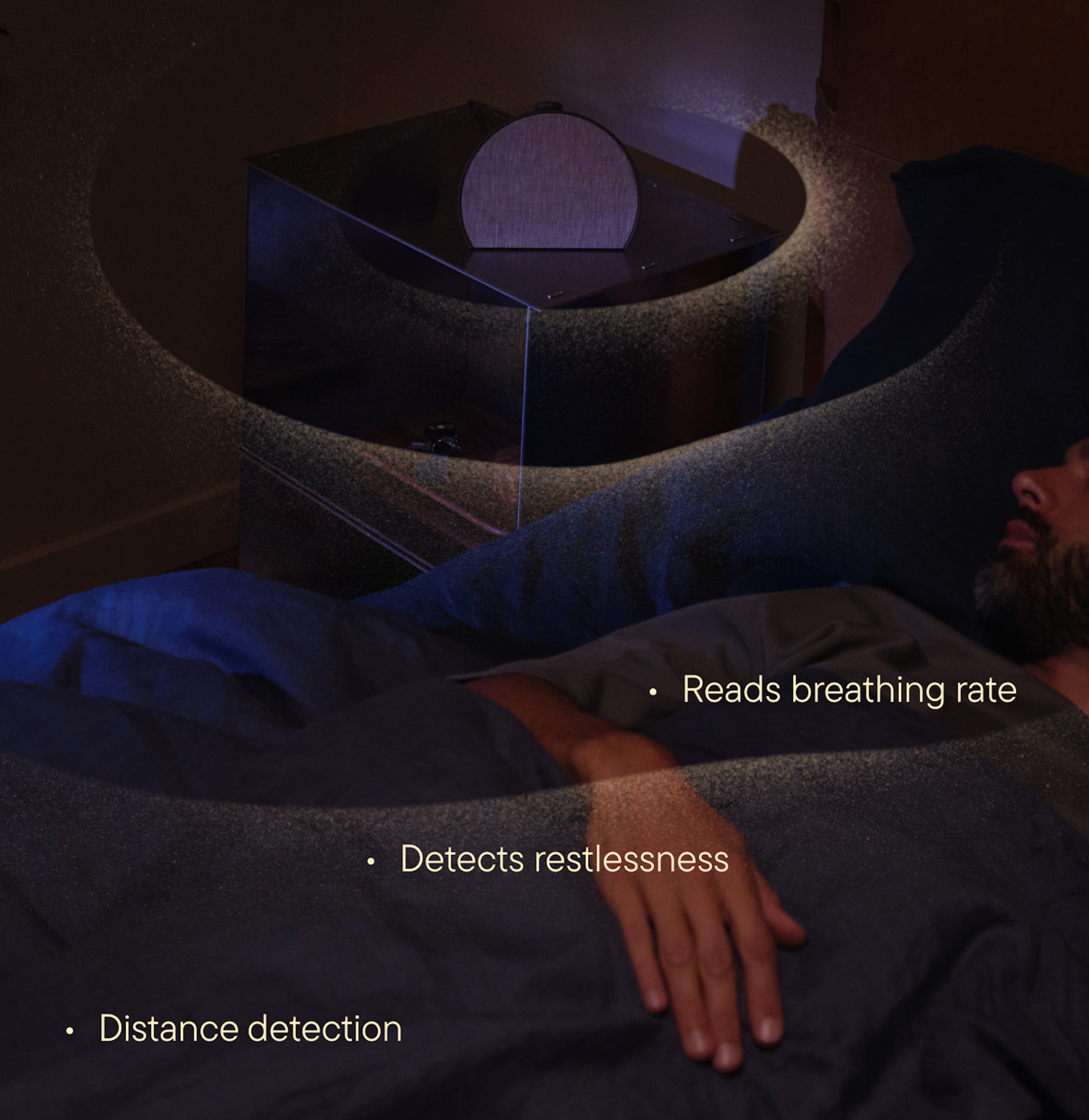 Person sleeping in bed while Hatch Sleep Clock tracks breathing and movement from the nightstand