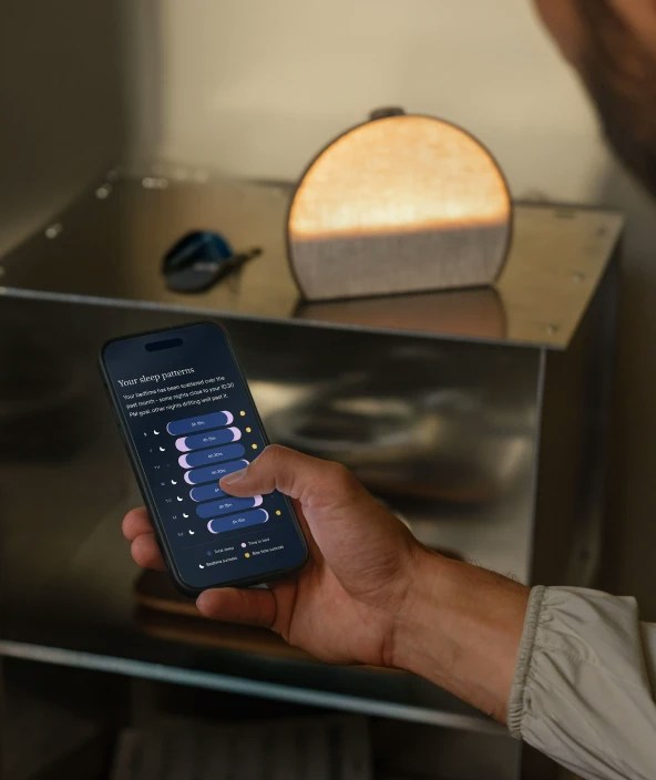 Man using the Hatch Sleep App to control his Hatch Sleep Clock