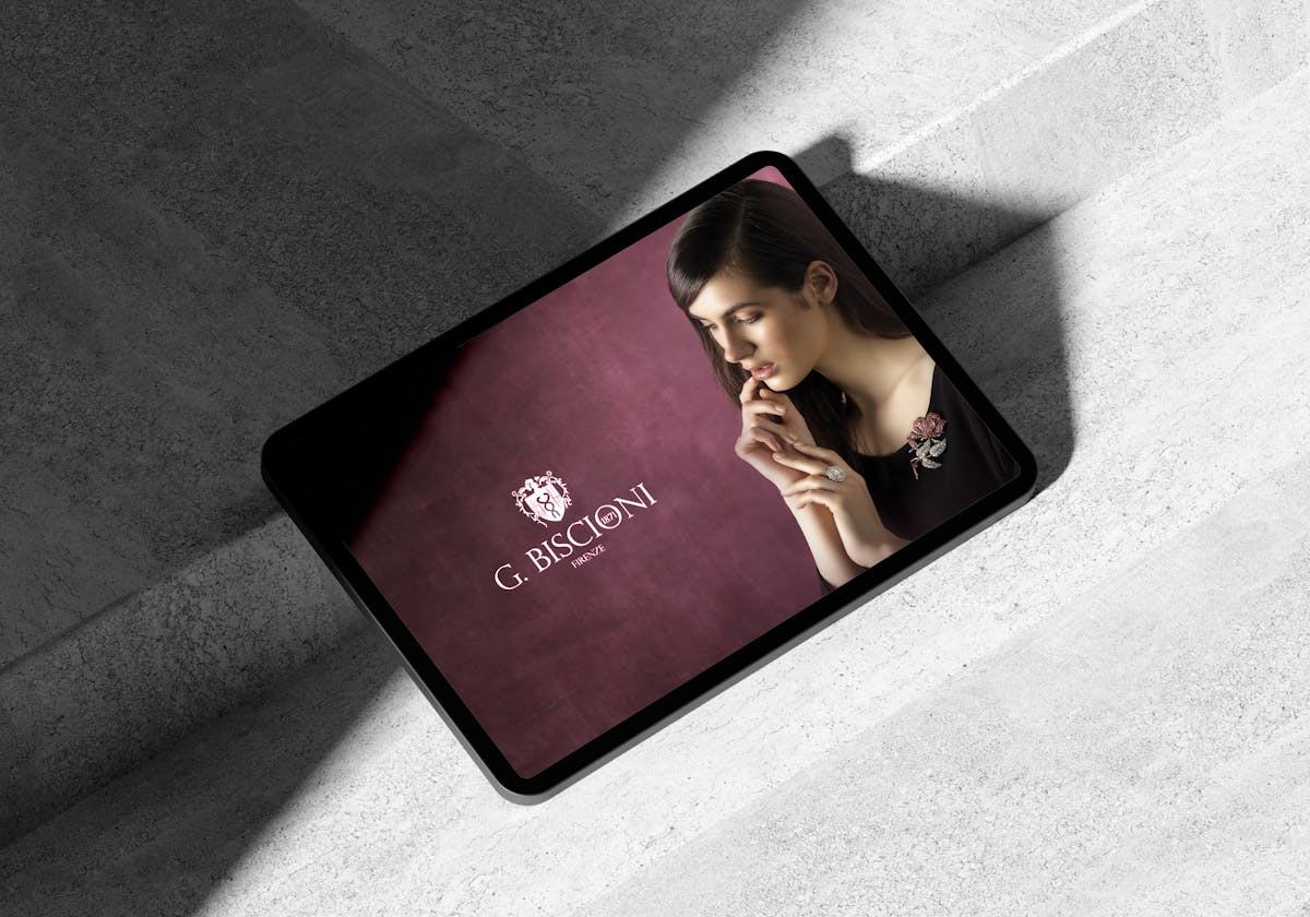 Homepage sito Biscioni Gioielli visualizzato su un tablet a sfondo grigio