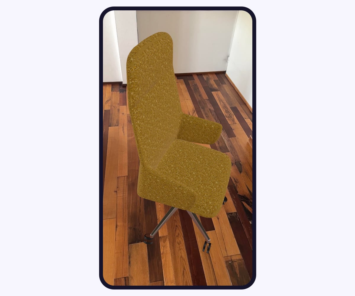 Smartphone screenshot in augmented reality: a chair in ochre bouclé fabric standing on the wooden floor of a real room, at real scale
