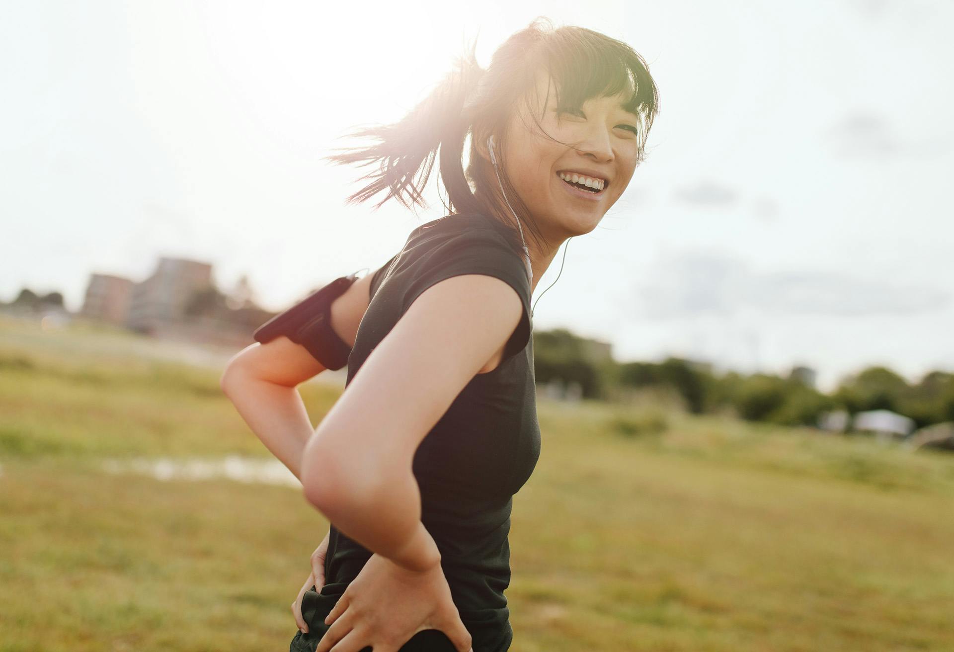Woman smiling outside while working out