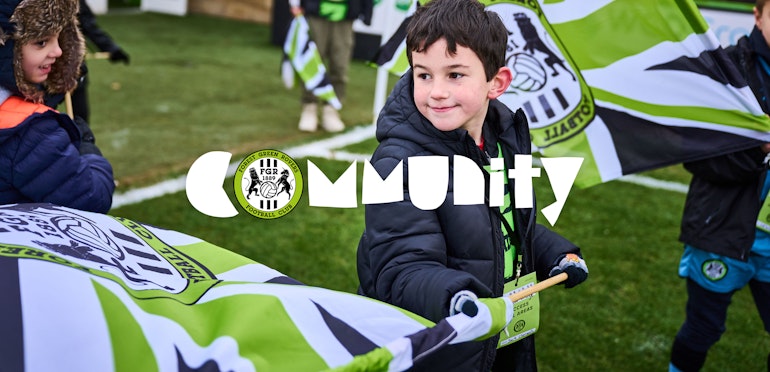 FGR Community rebranded logo with a club ambassador waving a flag