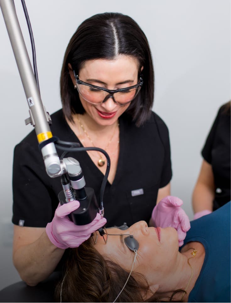 Dr. Moses preforming a procedure on a patient.