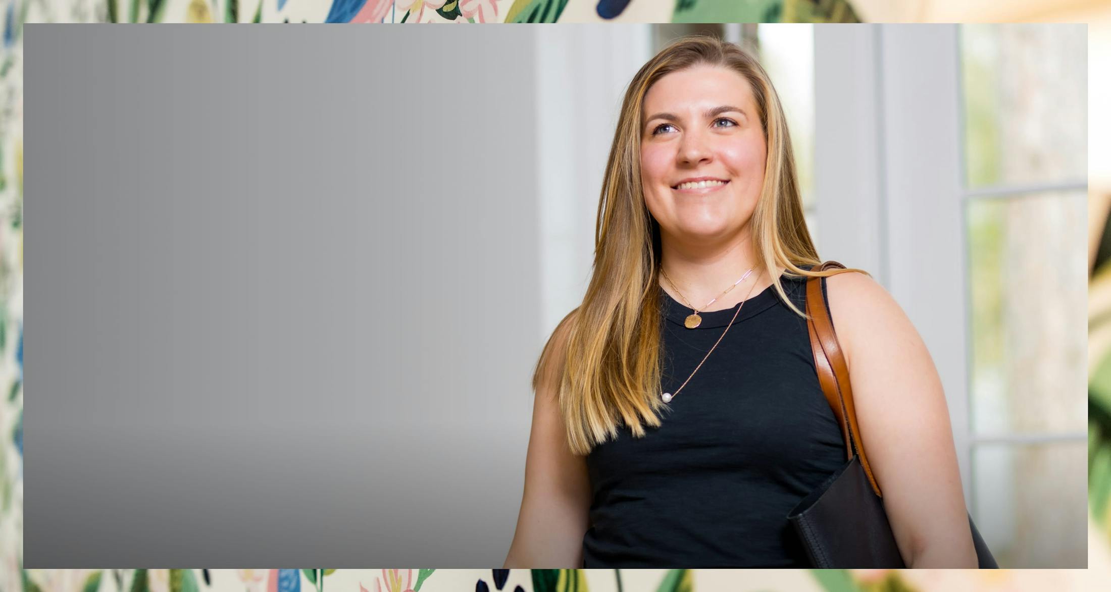 Medium shot of woman smiling looking off to camera left