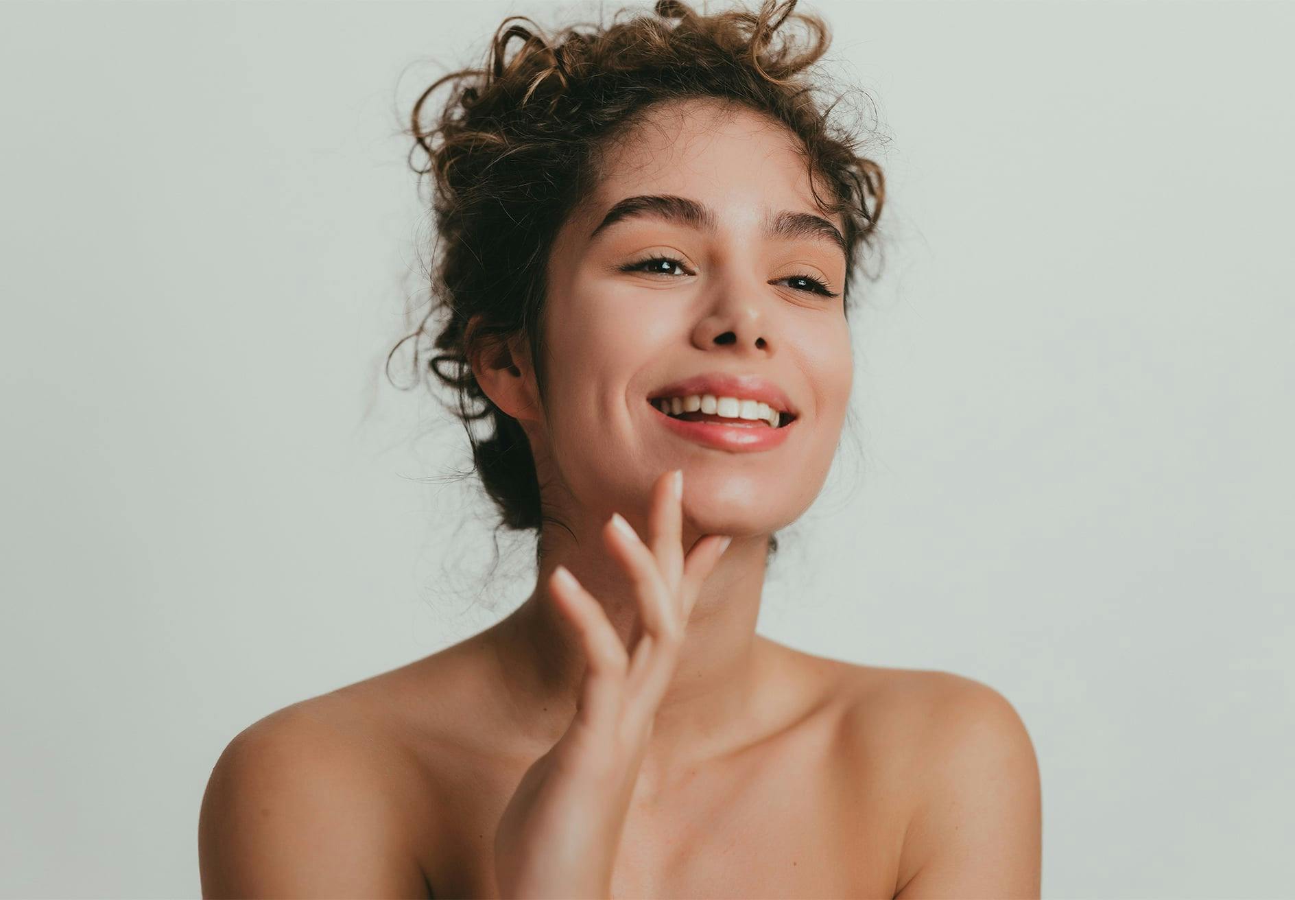 there is a woman with a smile touching chin