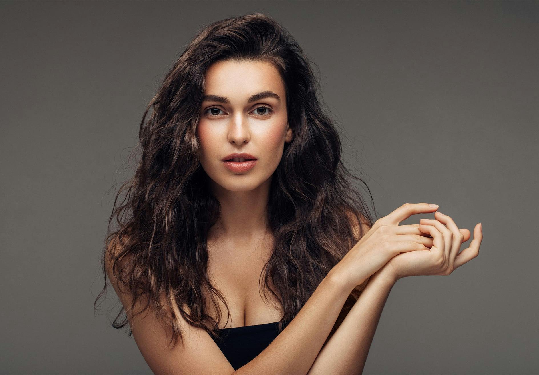woman with long dark hair posing for a picture