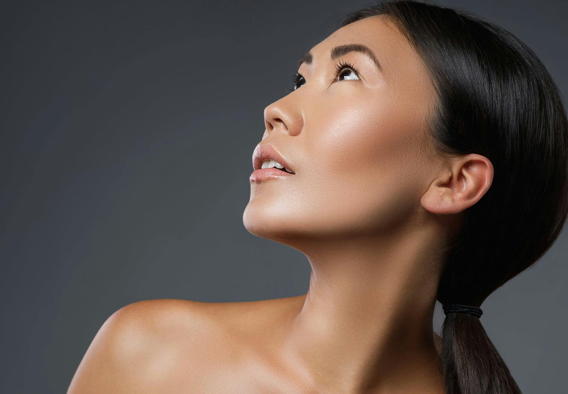 there is a woman with a ponytail looking up while posing for camera