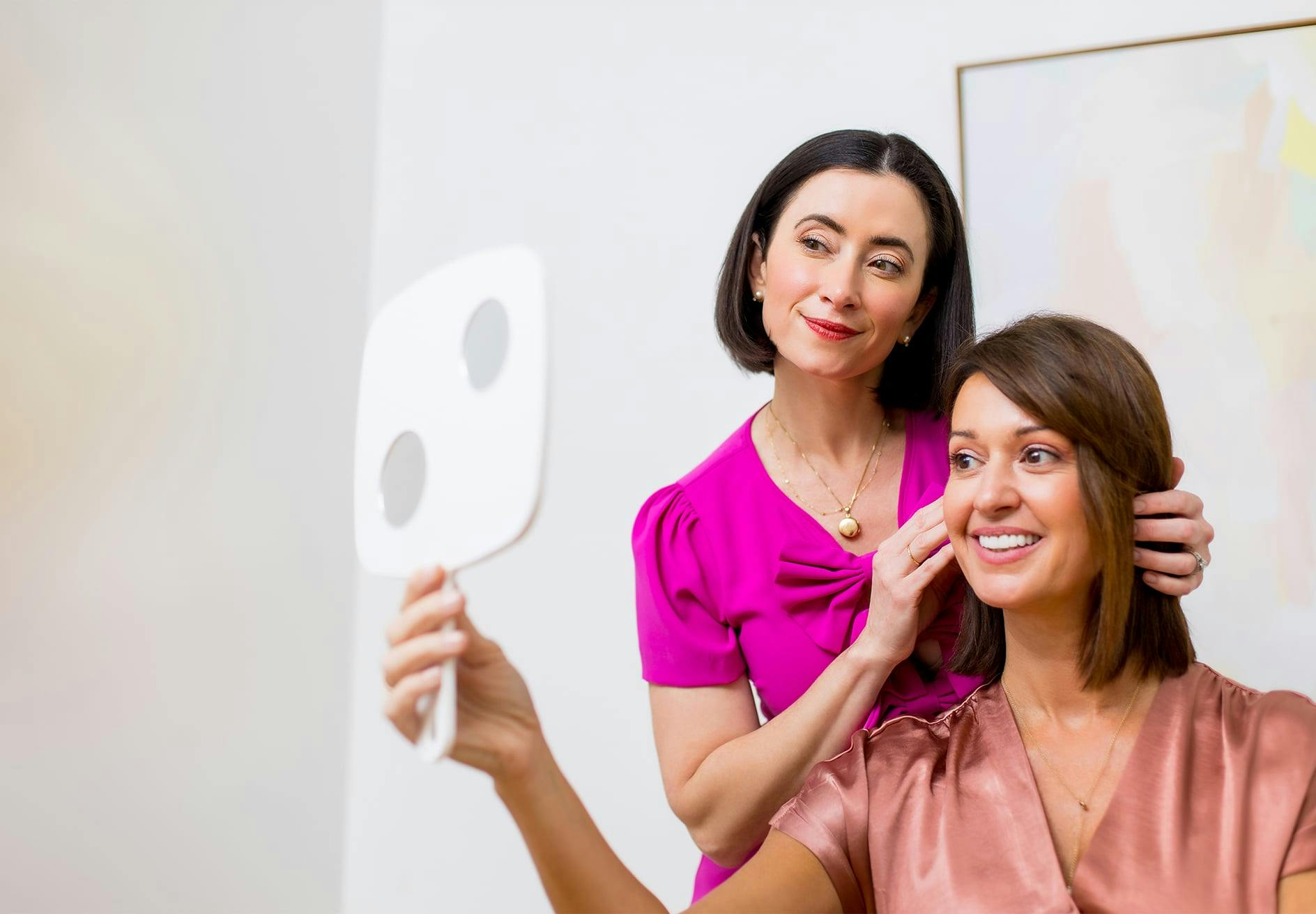 Dr. Helen Moses showing patient their face in mirror