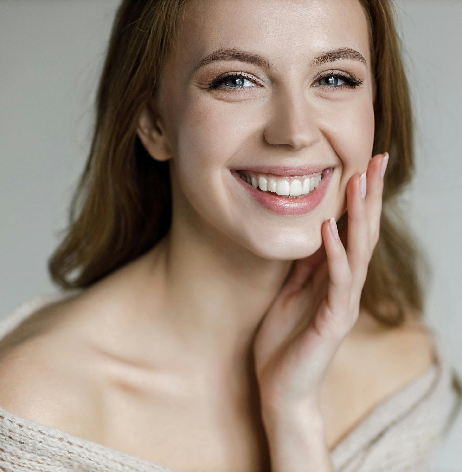smiling woman with hand on chin