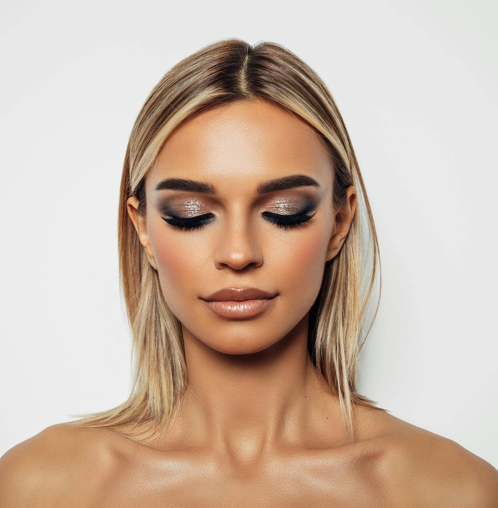 a close up of a woman with her eyes closed and shimmery eye shadow