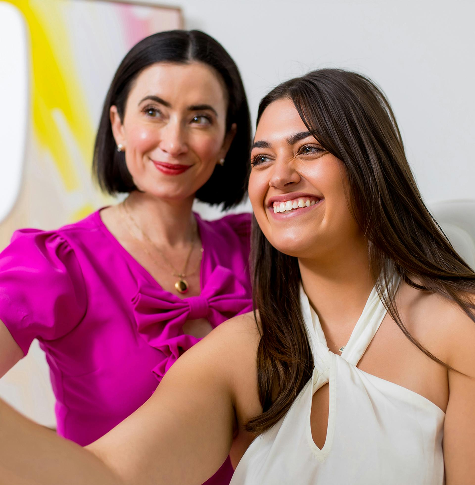 Dr. Helen Moses showing smiling patient their face in mirror