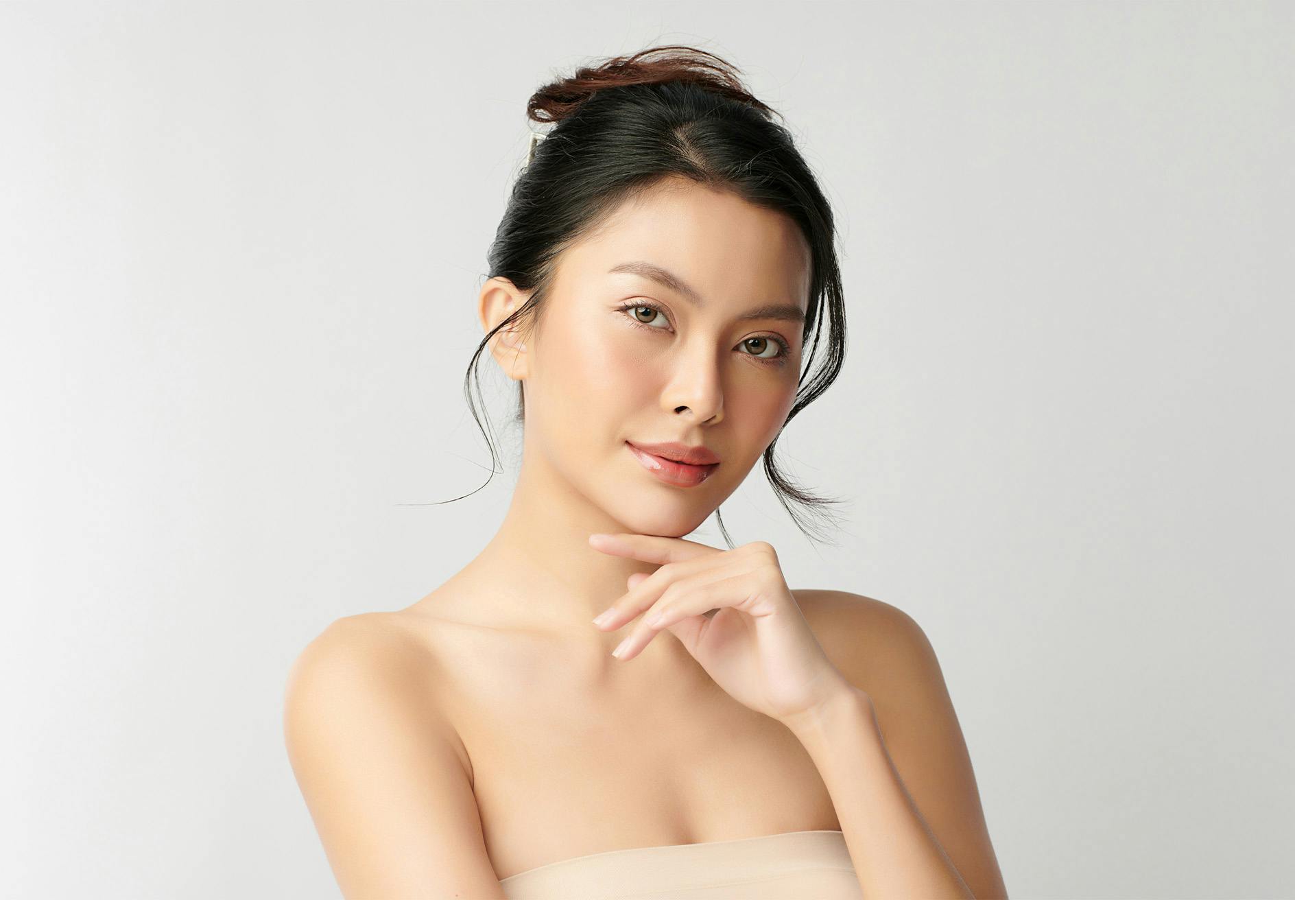 there is a woman in a strapless dress posing for a picture