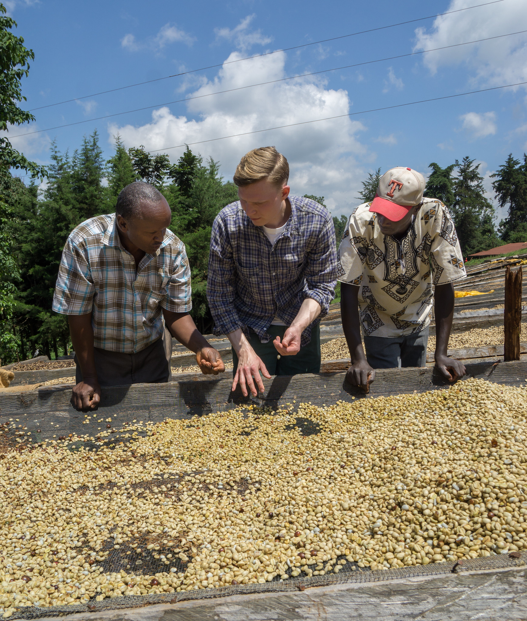 Kieni mill manager Josphat explain the drying process to our bar manager Jacob