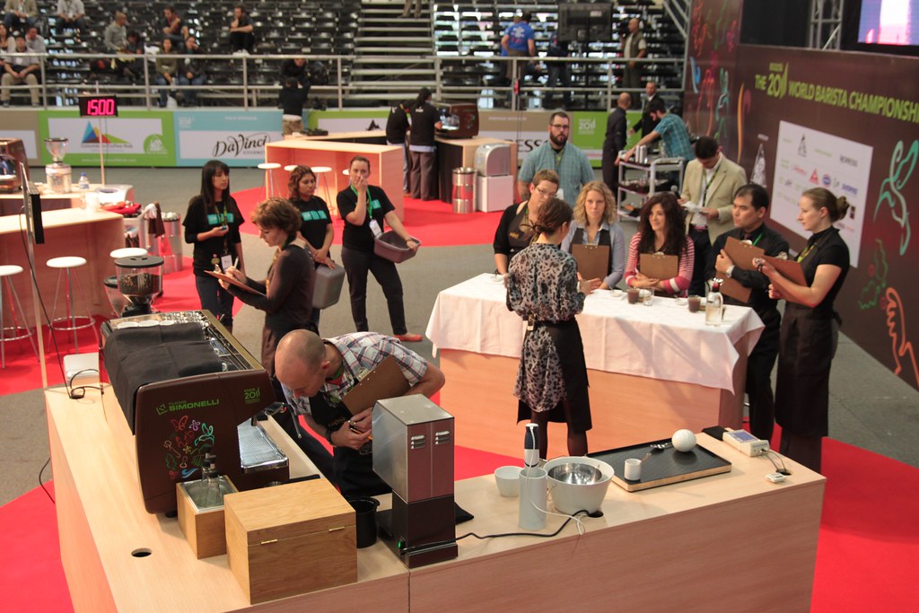 Tech judge checking the machine while AnneStine talks to the sensory judges.