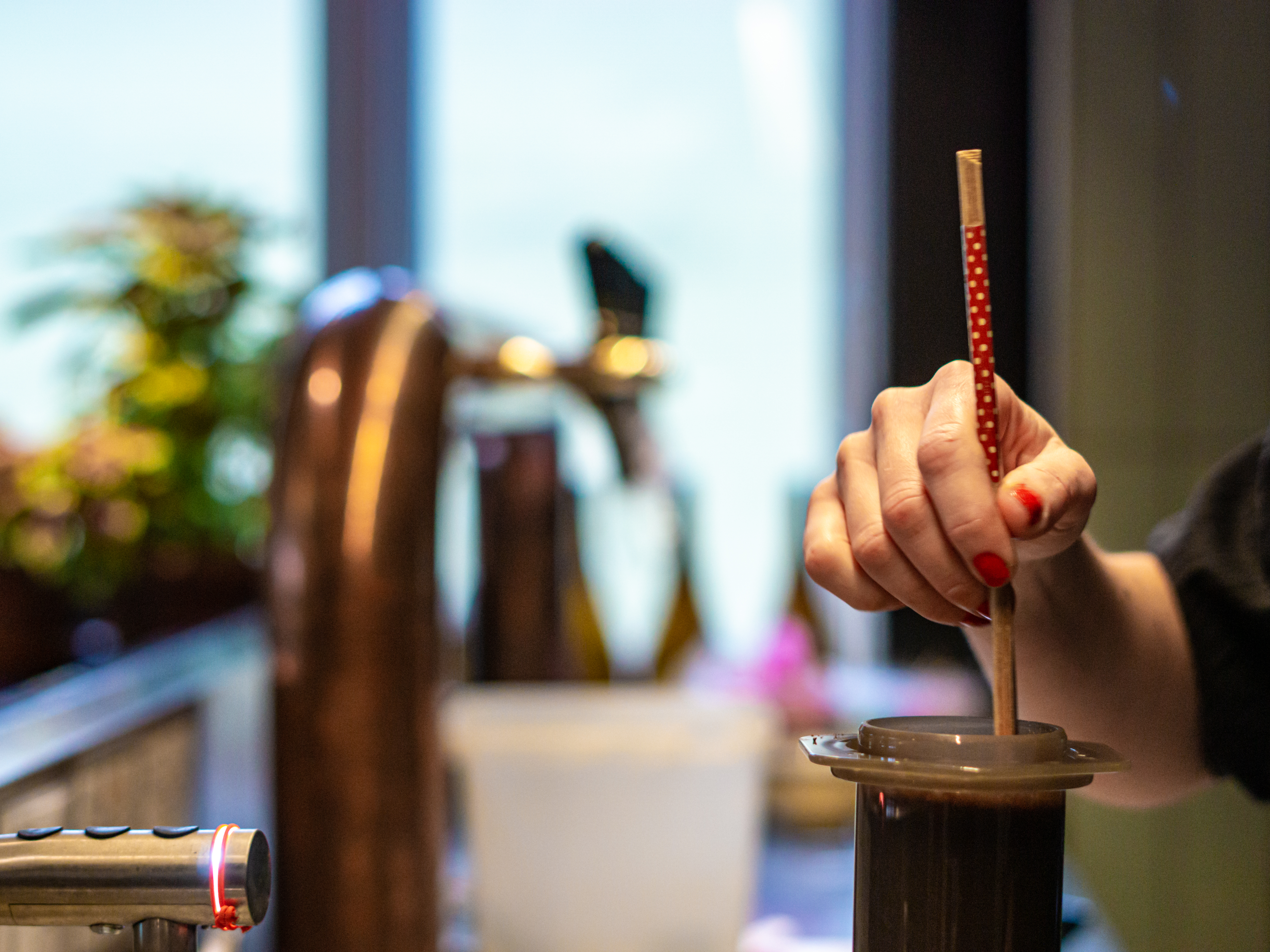 Carefully brewing the AeroPress following the recipe developed in-house 