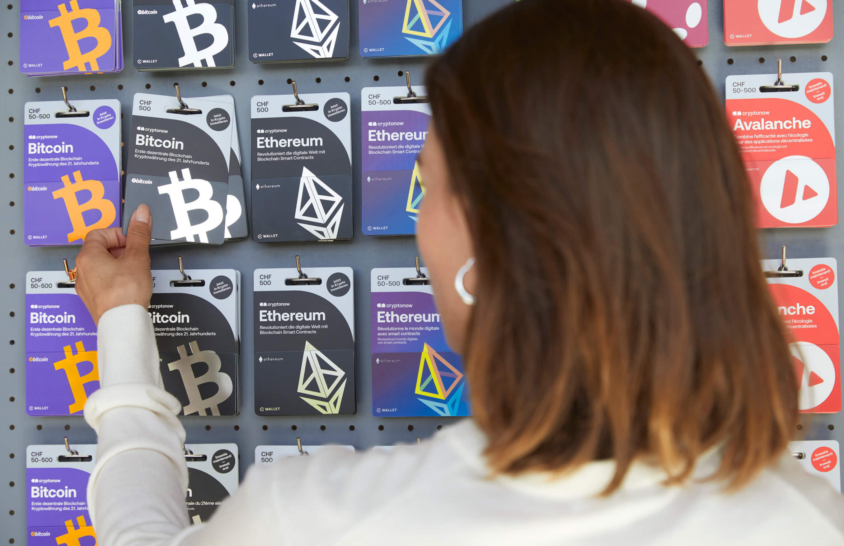 A person buys a Cryptonow gift card in the store