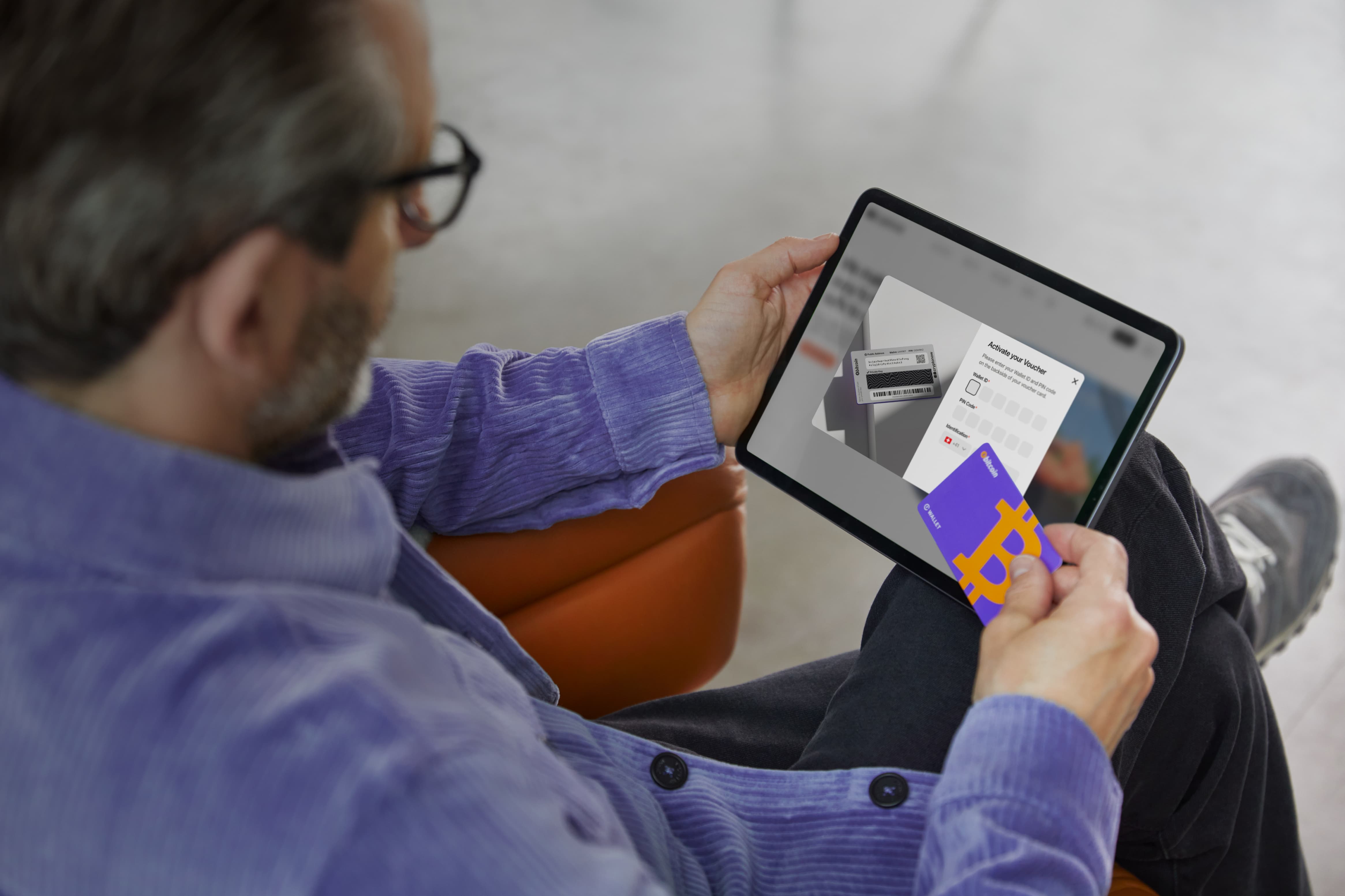 Guy with a purple sweater initiates Cryptonow card activation.