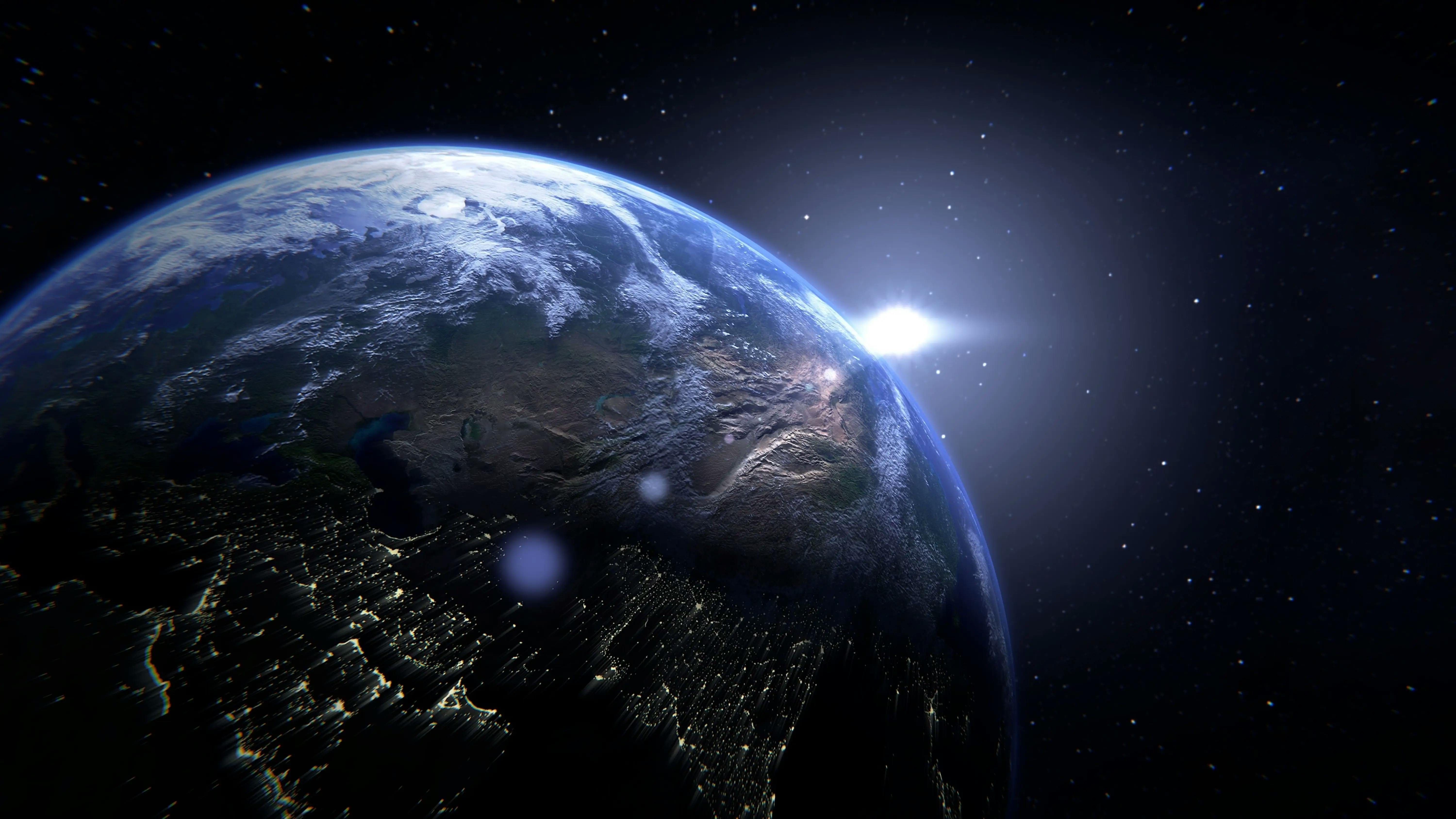 Close up view of the earth, with the sun shining on the horizon.
