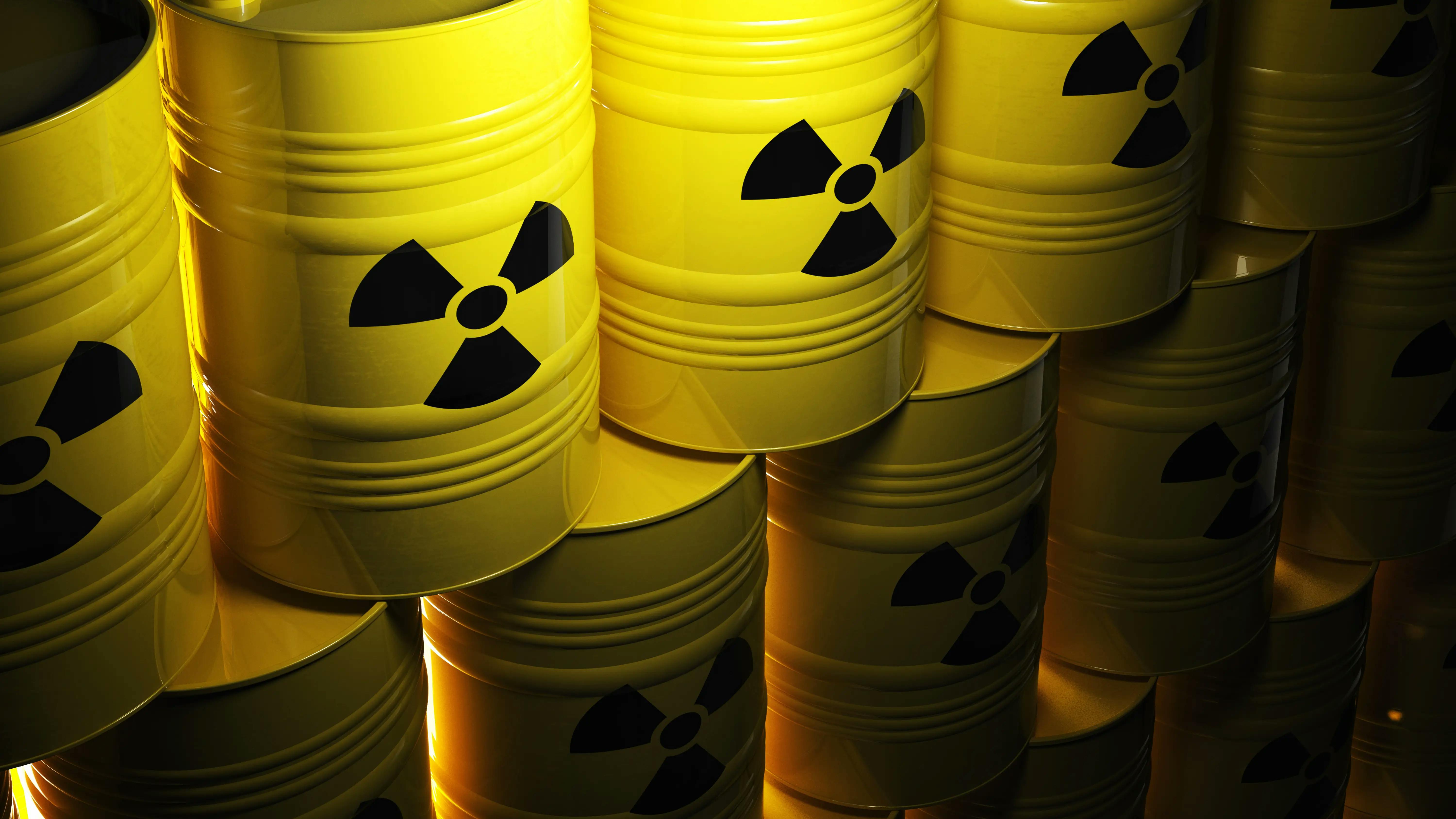 Barrels stamped with the radioactive material stacked on top of each other.